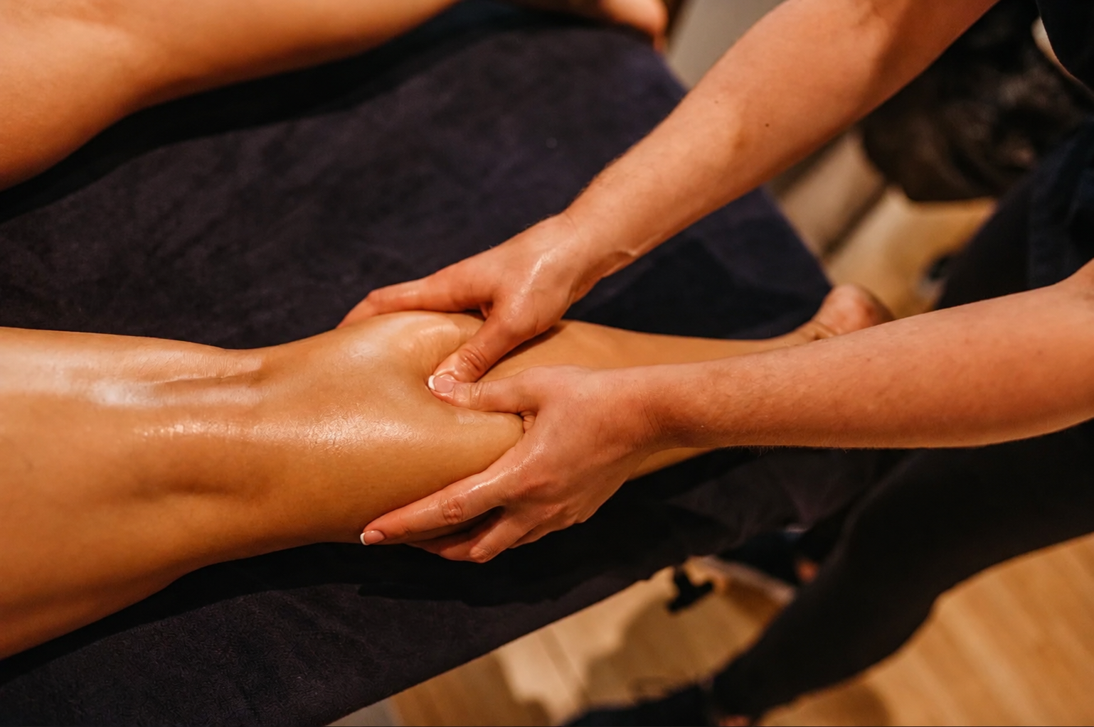 Therapist providing focused calf massage