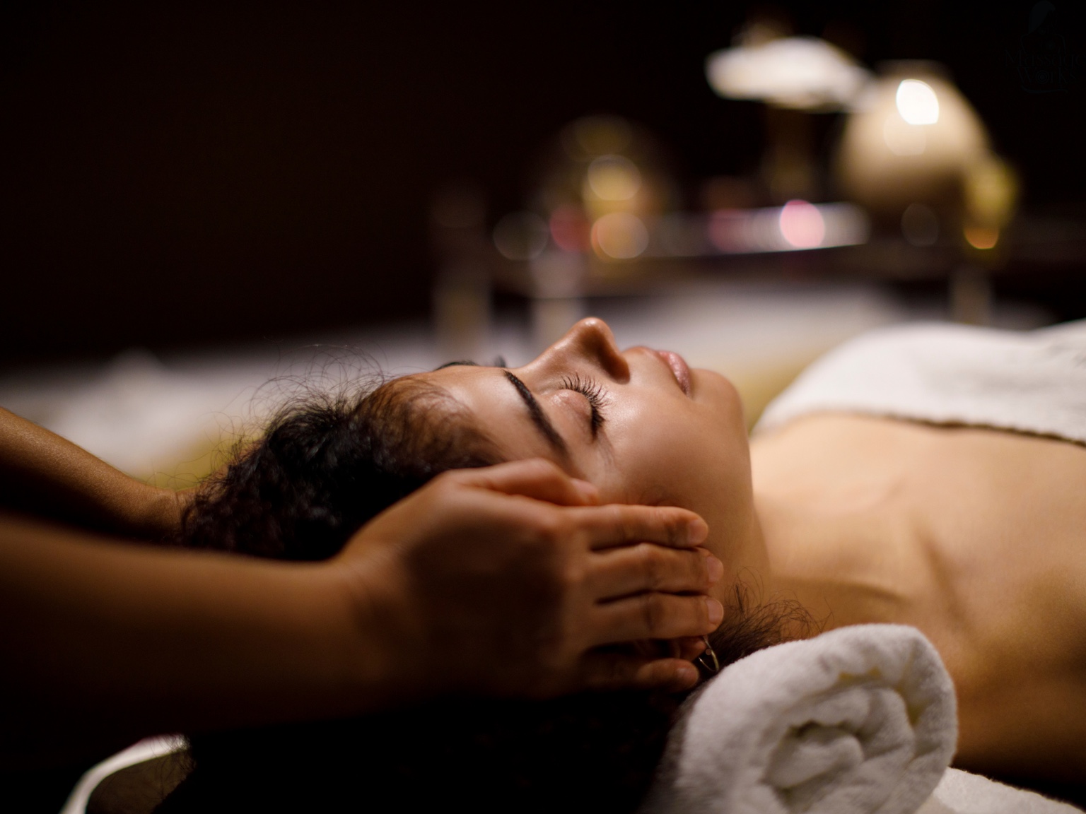 Woman relaxing during a gentle head and neck massage
